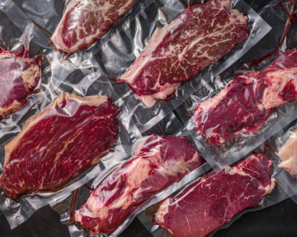 Set  of  vacuum packed organic raw beef alternative cuts: top blade, rump, picanha, chuck roll steaks, over black textured background, top view